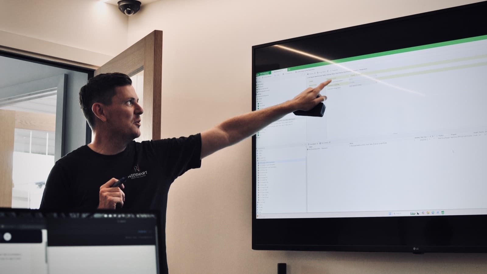 A Neosmart consultant commissioning and reviewing a home automation system on site